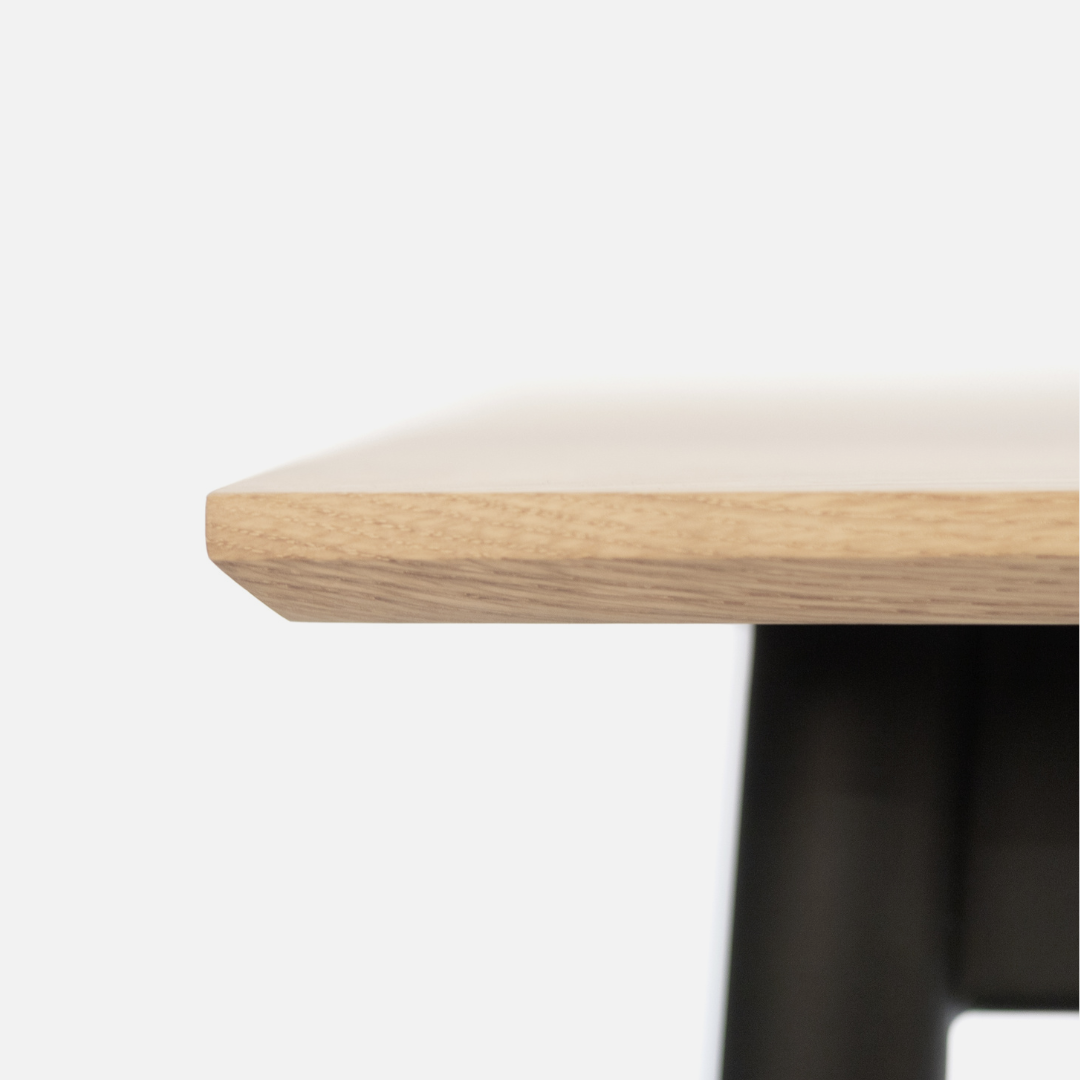 Close-up of a wooden table edge on a white background