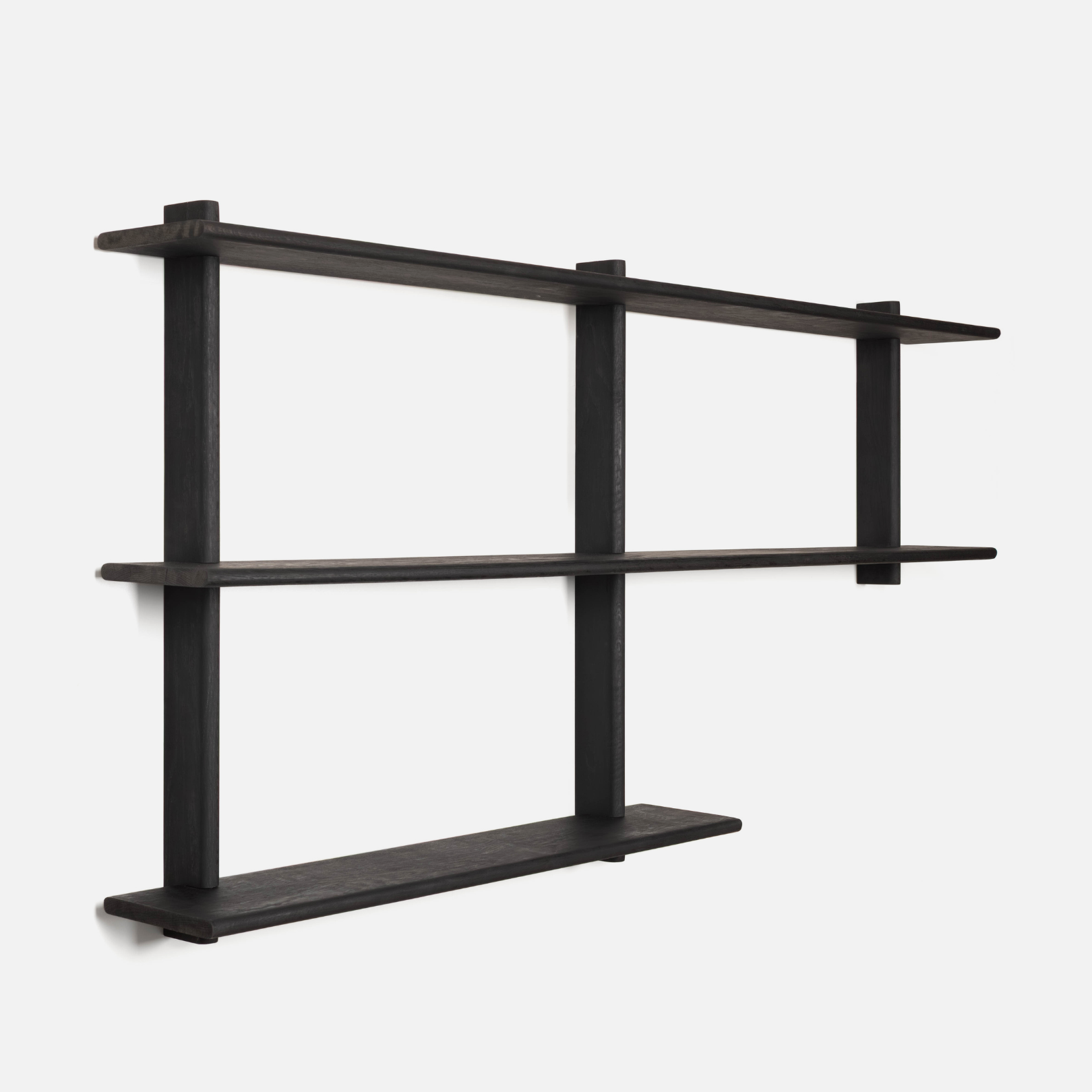 Black wall-mounted shelf with three shelves on a white background