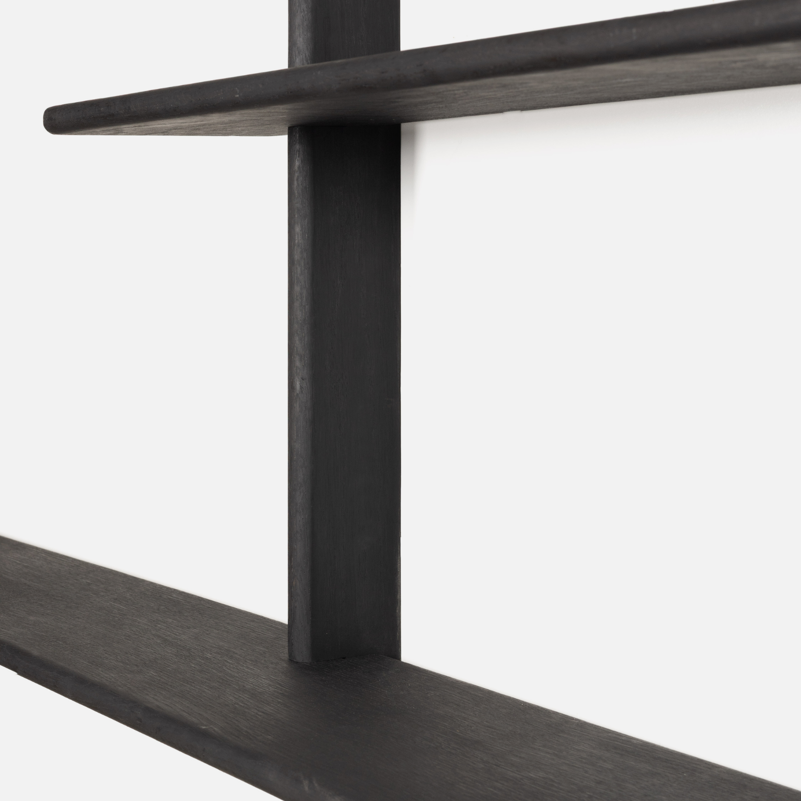 Close-up of a black Oak shelf with a white background