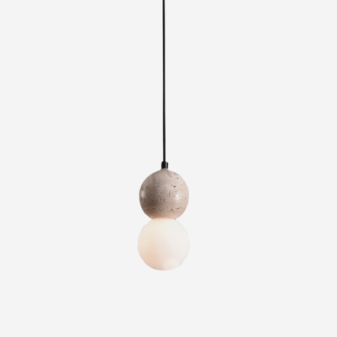 Pendant light with a round, textured shade on a white background