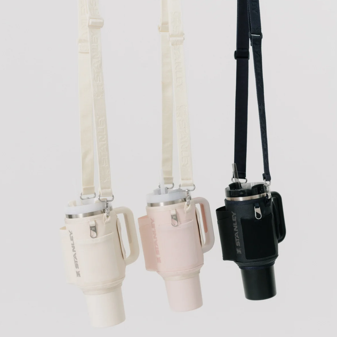 Three Stanley Bottles with straps on a light grey background