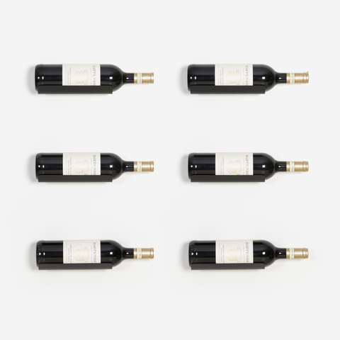 A set of six black floating wine brackets designed to mount to a wall for wine storage.