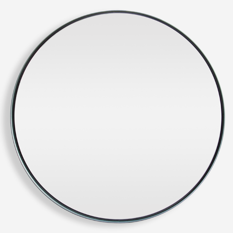 A large round mirror with a matte black powder-coated steel frame, sitting flush against the wall.