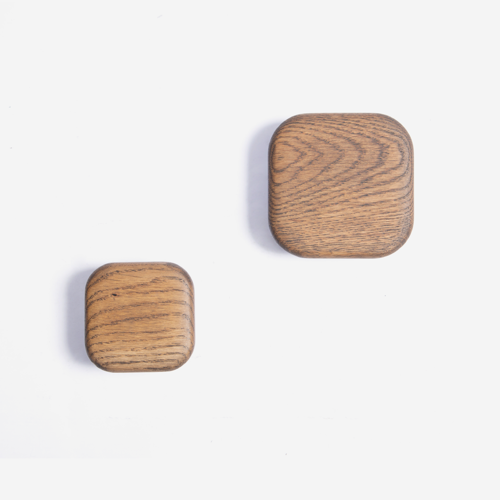 Two dark oak squared wall hooks of different sizes placed against a white background.