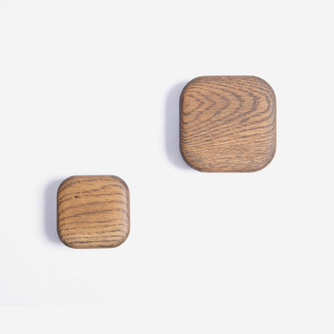 Two dark oak squared wall hooks of different sizes placed against a white background.